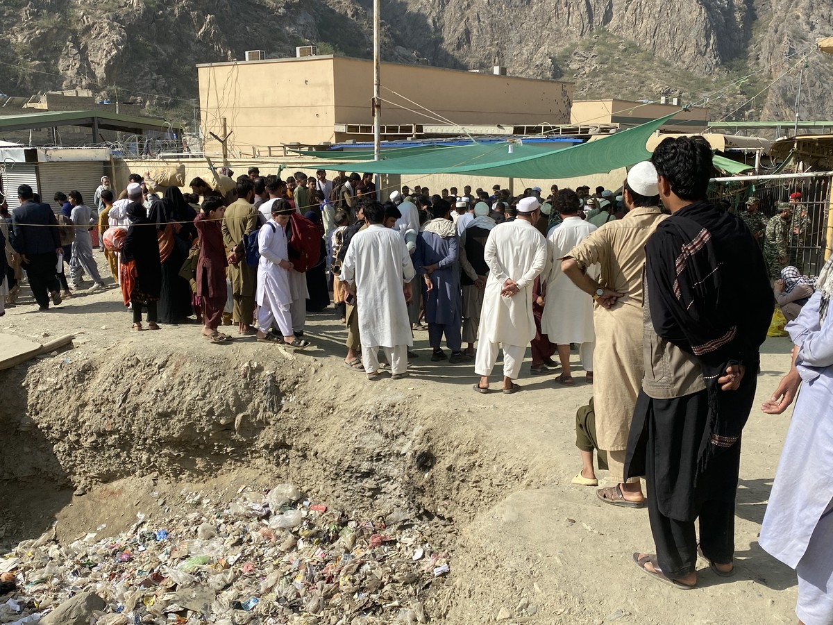 epa12497428 Afghan refugees gather near a registration center as they prepare to return after the reopening of the Torkham border in Pakistan, 01 November 2025. Pakistan has partially reopened the bor ...