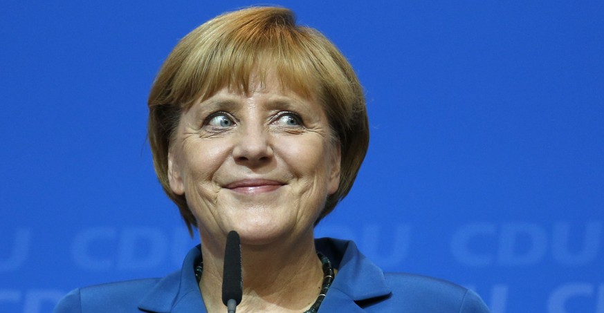 FILE - In this Sunday, Sept. 22, 2013 file photo, German Chancellor Angela Merkel, chairwoman of the Christian Democratic party CDU, smiles as she talks to her supporters at the party headquarters in  ...