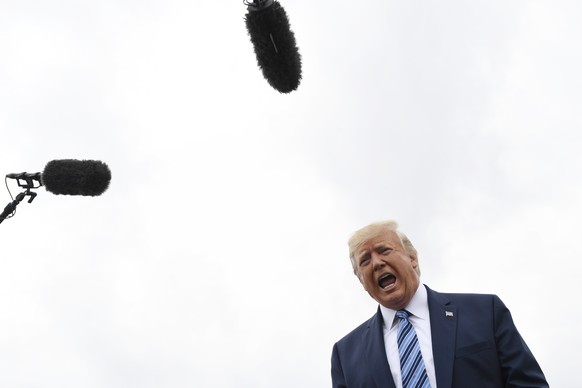 President Donald Trump talks to the media before boarding Air Force One at Morristown Municipal Airport in Morristown, N.J., Tuesday, Aug. 13, 2019. Trump is heading to Monaca, Pa., about 40 minutes n ...