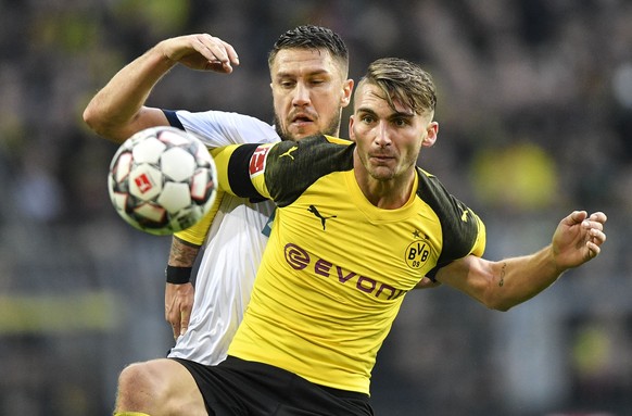 Dortmund's Maximilian Philipp, in front, and Hoffenheim's Ermin Bicakcic challenge for the ball during the German Bundesliga soccer match between Borussia Dortmund and TSG 1899 Hoffenheim in Dortmund, ...