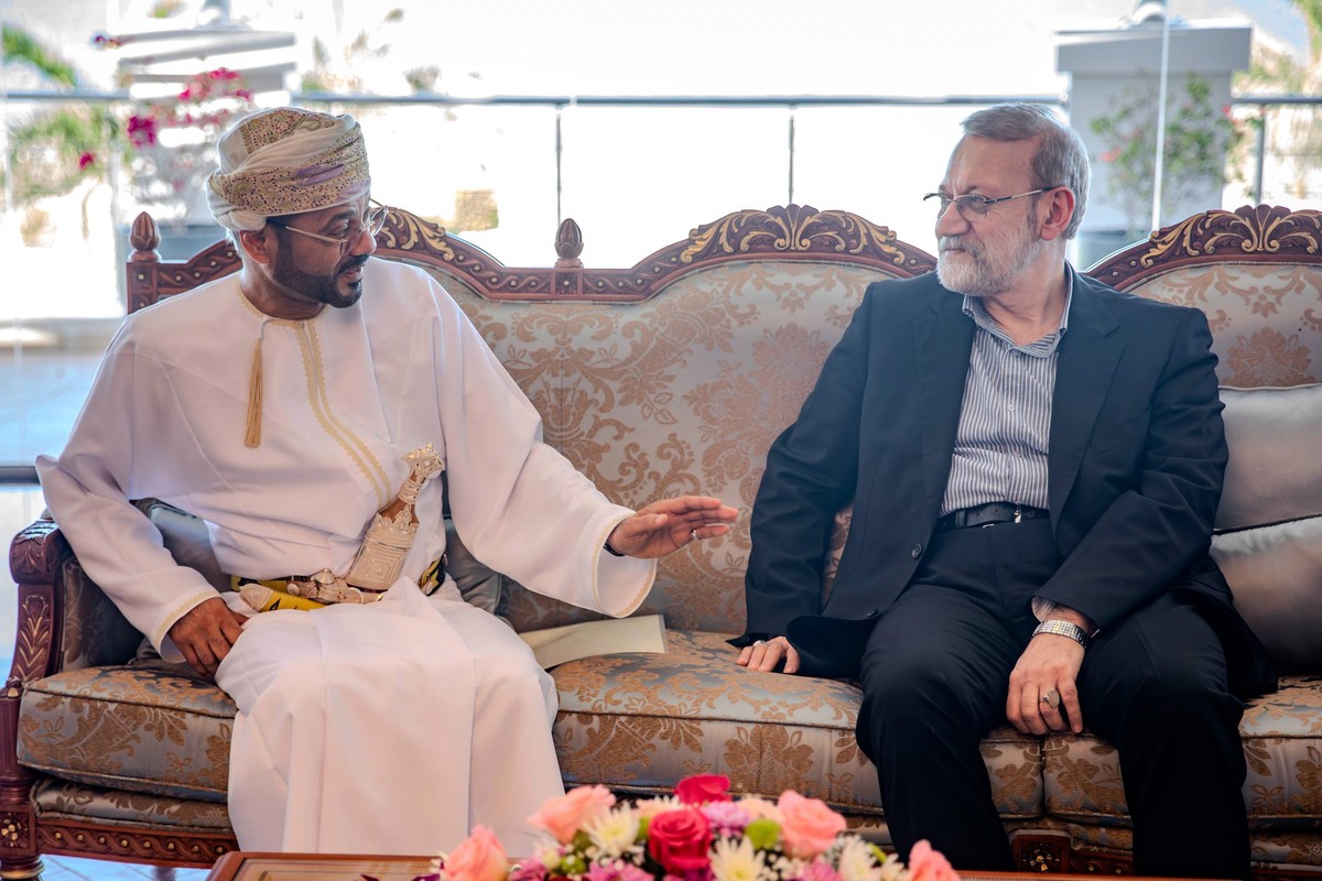 In this photo released by Iran's Supreme National Security Council office, Secretary of the Supreme National Security Council Ali Larijani, right, listens to Omani Foreign Minister Badr al-Busaid ...