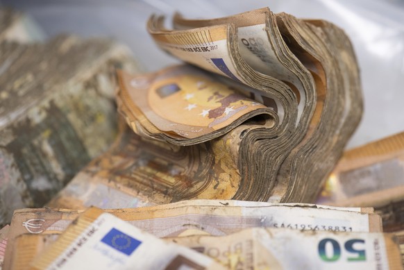 Soaked and mouldy euro banknotes are waiting to be dried at the Bundesbank in Mainz, Germany, Wednesday, Sept. 1, 2021. Germany