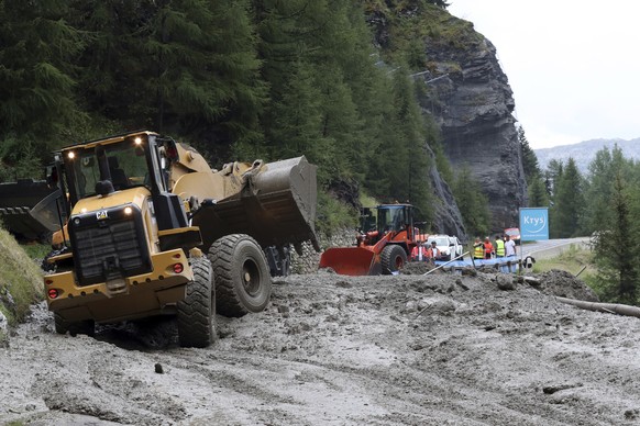 Worker use diggers to clean the road of the nineteenth stage of the Tour de France cycling race over 126,5 kilometers (78,60 miles) with start in Saint Jean De Maurienne and finish in Tignes, France,  ...