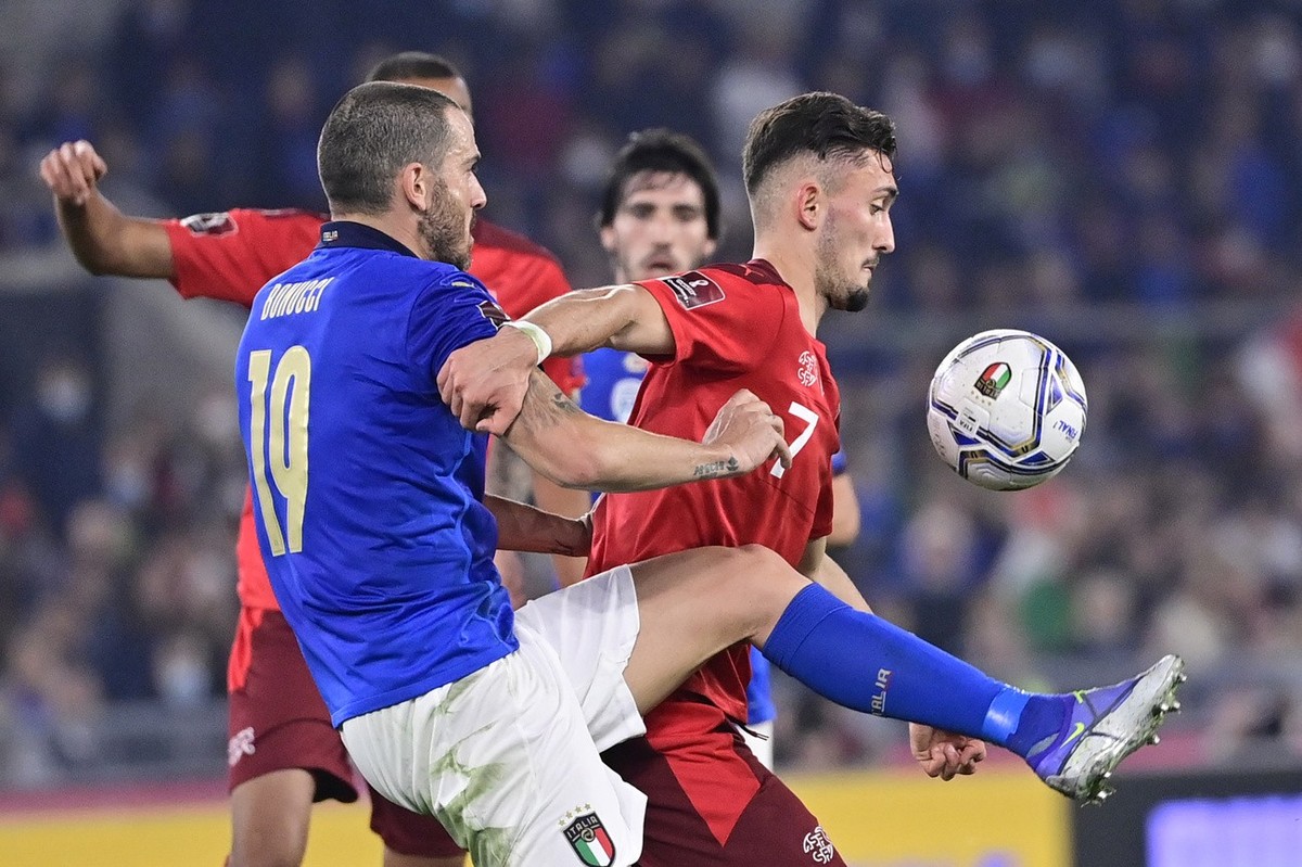 Italy's defender Leonardo Bonucci, left, fights for the ball against Switzerland's forward Andi Zeqiri, right, during the 2022 FIFA World Cup European Qualifying Group C match between Italy  ...