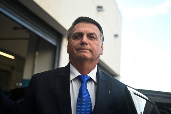 epa10742615 Former Brazilian President Jair Bolsonaro reacts after leaving the headquarter of the Federal Police in Brasilia, Brazil, 12 July 2023. Bolsonaro presented his testimony in a case of alleg ...