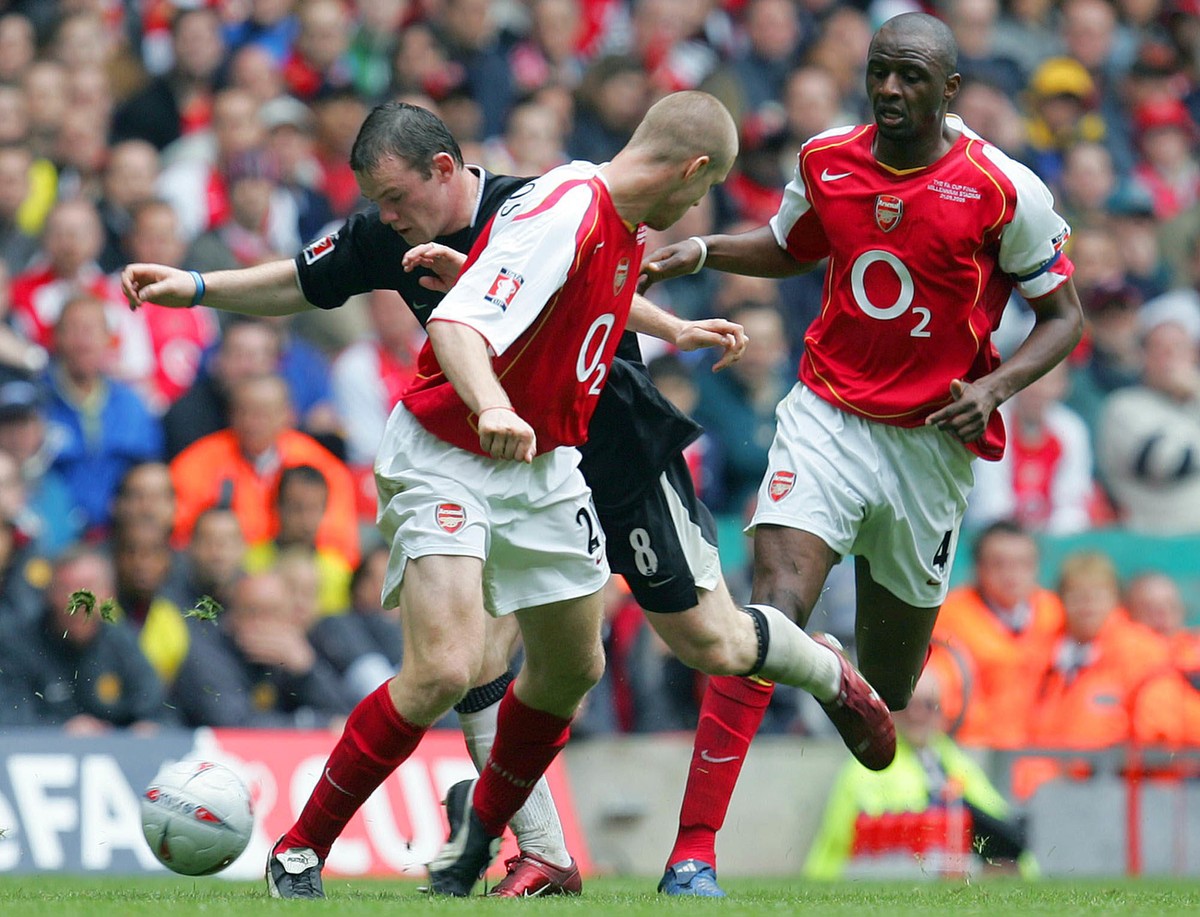 Manchester United's Wayne Rooney, rear left, takes on Arsenal's Philippe Senderos, center, and Patrick Vieira during the FA Cup Final at the Millennium Stadium in Cardiff, Wales Saturday May ...