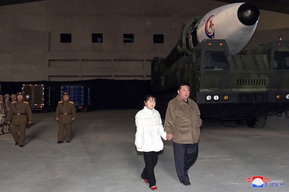 epa10313517 A photo released by the official North Korean Central News Agency (KCNA) shows North Korean leader Kim Jong-Un, accompanied by his daughter during the test firing of a new type of intercon ...