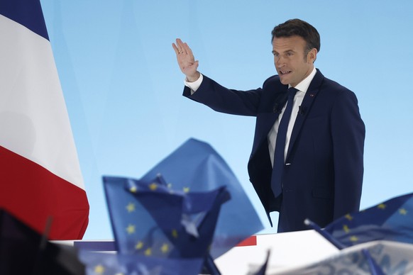 epa09883567 French President and candidate for re-election Emmanuel Macron reacts after results in the first round of the French presidential elections in Paris, France, 10 April 2022. According to in ...