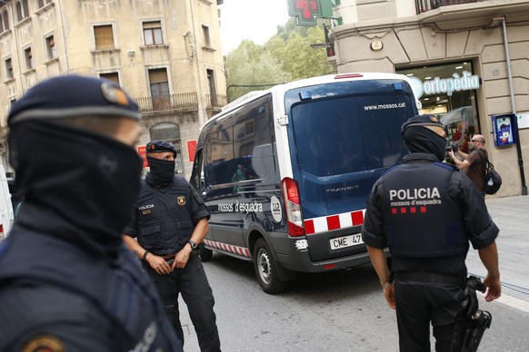 A police van drives away with a detained suspect after a search of a building in Ripoll, north of Barcelona, Spain, Friday, Aug. 18, 2017. Police on Friday shot and killed five people carrying bomb belts who were connected to the Barcelona van attack, as the manhunt intensified for the perpetrators of Europe's latest rampage claimed by the Islamic State group. (AP Photo/Francisco Seco)