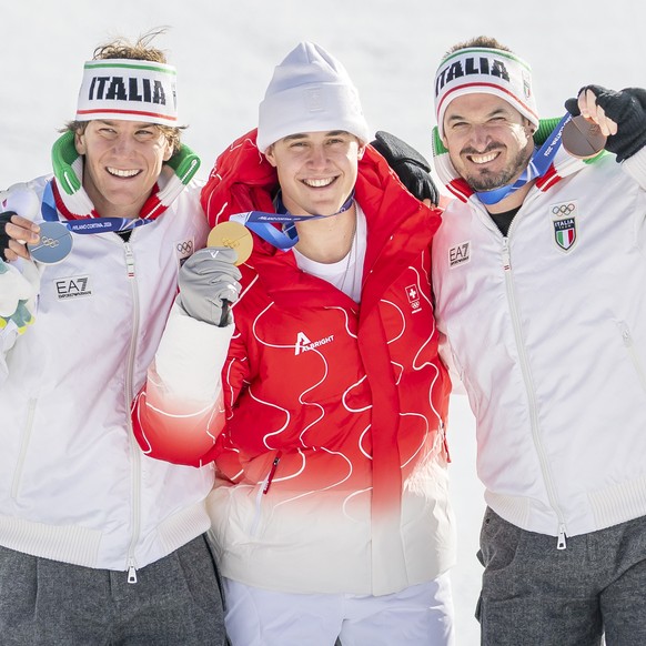Gold medalist Switzerland's Franjo von Allmen, center, poses next to silver medalist Italy's Giovanni Franzoni, left, and bronze medalist Italy's Dominik Paris, right, during the medal  ...