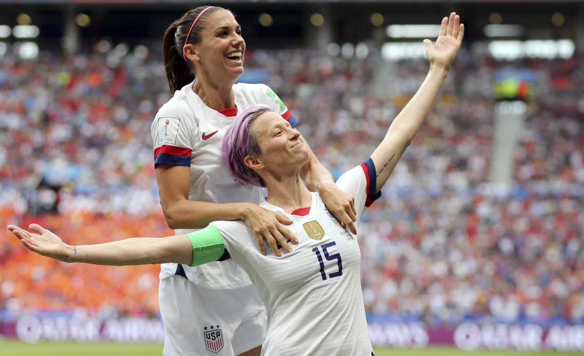 United States' Megan Rapinoe, right, celebrates after scoring the opening goal from the penalty spot during the Women's World Cup final soccer match between US and The Netherlands at the Sta ...