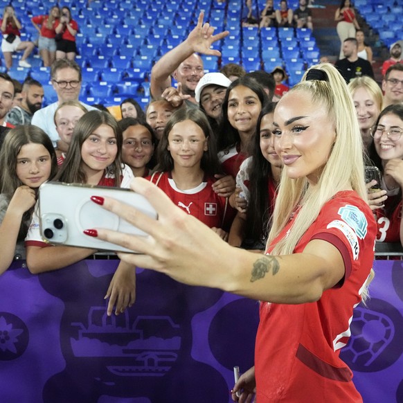 Switzerland&#039;s Alisha Lehmann takes a selfie with fans at the end of the Euro 2025, group A, soccer match between Switzerland and Norway at St. Jakob-Park in Basel, Switzerland, Wednesday, July 2, ...
