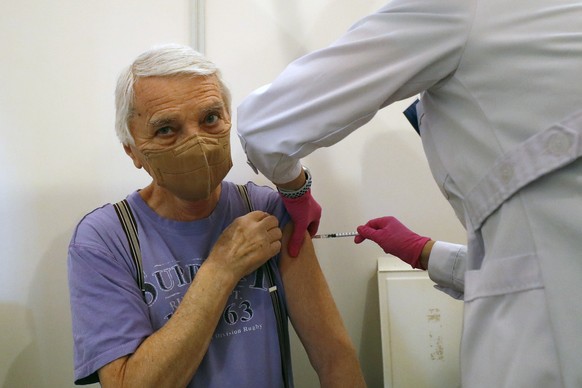 An elderly man receives the Pfizer COVID-19 vaccine at the Church of St. Anthony of Padua in Sokolov, Czech Republic, Tuesday, March 16, 2021. As of Tuesday, the Czech Republic has administered 1,119, ...