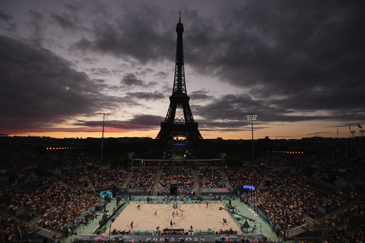 The Eiffel Tower is seen in the background during play in the women's beach volleyball bronze medal match between Australia, left, and Switzerland, at the 2024 Summer Olympics, Friday, Aug. 9, 20 ...