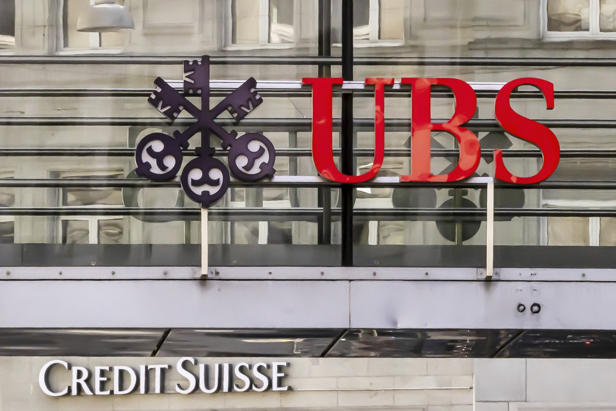 Logos of the Swiss banks Credit Suisse and UBS are seen on two buildings in Zurich, Switzerland, Saturday, March 18, 2023. (Michael Buholzer/Keystone via AP)