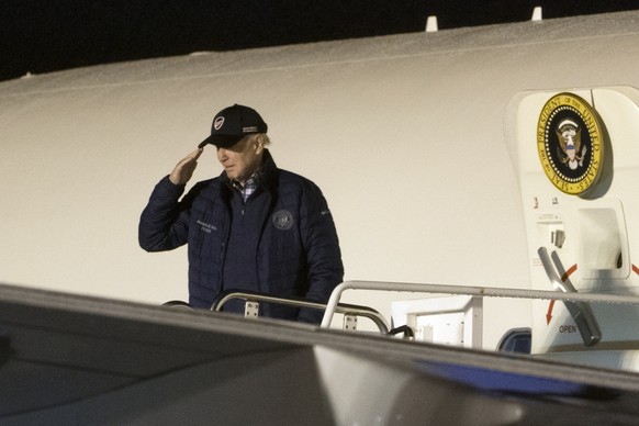 President Joe Biden salutes as he boards Air Force One at Dover Air Force Base, in Dover, Del., Sunday, Oct. 23, 2022. The Bidens are returning back to the White House after spending the weekend at th ...