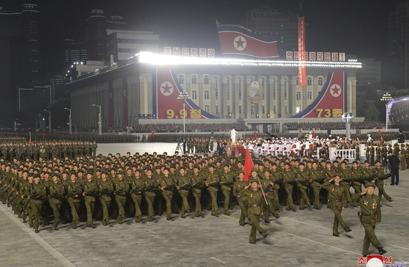 In this photo provided by the North Korean government, North Korean soldiers parade during a celebration of the nation