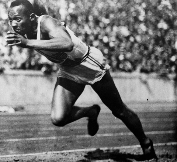 FILE - In this 1936 file photo, Jesse Owens of the United States runs in a 200-meter preliminary heat at the 1936 Summer Olympics in Berlin. Owens won four gold medals at the 1936 Berlin Olympics and  ...