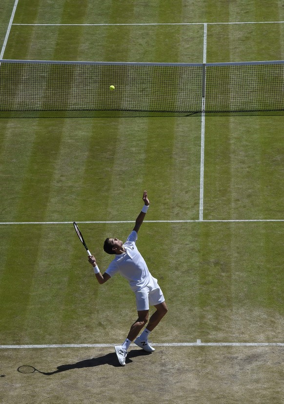 epa05410603 Milos Raonic of Canada serves to Sam Querrey of the US in their quarter final match during the Wimbledon Championships at the All England Lawn Tennis Club, in London, Britain, 06 July 2016 ...