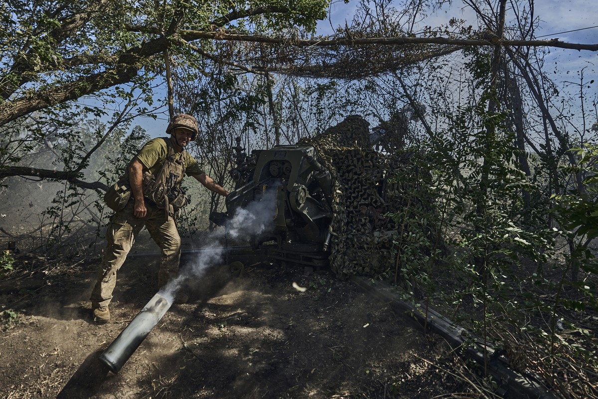 A Ukrainian serviceman of the 31 Brigade fires a D-30 cannon towards Russian positions at the front line in Donetsk region, Ukraine, Wednesday, Aug. 9, 2023. (AP Photo/Libkos)