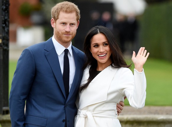 epa06354052 Britain&#039;s Prince Harry pose with Meghan Markle during a photocall after announcing their engagement in the Sunken Garden in Kensington Palace in London, Britain, 27 November. Clarence ...