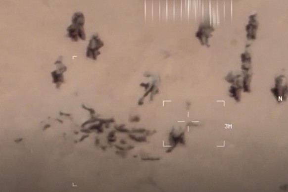 This image taken from a video shows soldiers burying bodies near an army base in northern Mali. The French military says it has videos of Russian mercenaries burying bodies near an army base in northe ...