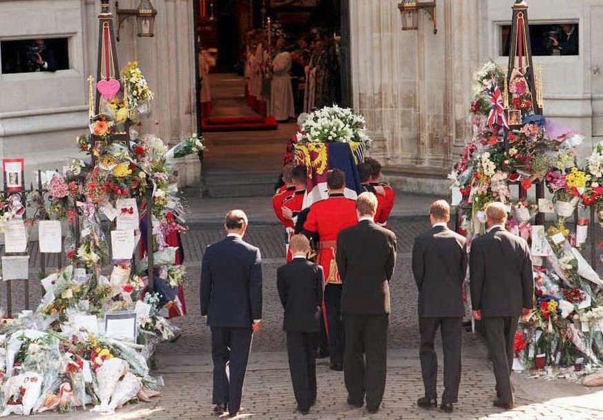 The coffin of Diana, Princess of Wales is carried into Westminster Abbey by the bearer party of Welsh Guardsmen for her funeral 06 September 1997 followed by (l/r) the Prince of Wales, Prince Harry, t ...