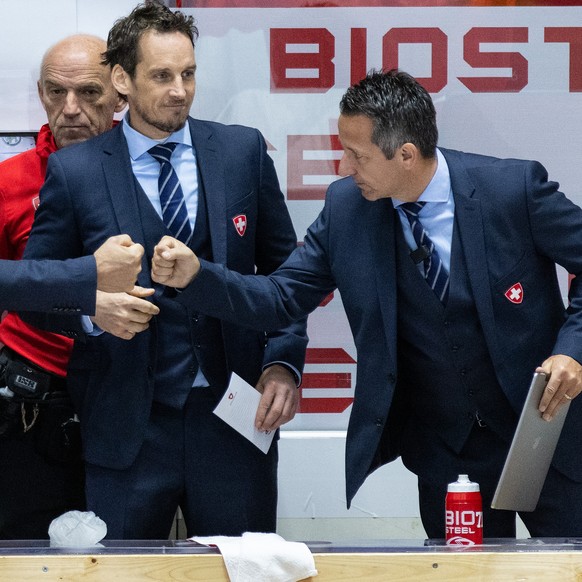 Switzerland&#039;s head coach Patrick Fischer, center, and Tommy Albelin, assistant coach, left, and Marco Bayer, assistant coach, right, celebrate their victory after the Ice Hockey World Championshi ...