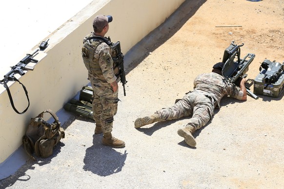 epaselect epa13144685 Lebanese Army soldiers monitor the movements of Israeli forces stationed in a neighboring village, in Zawtar al-Gharbiyah, Nabatieh Governorate, southern Lebanon, 31 July 2026, f ...