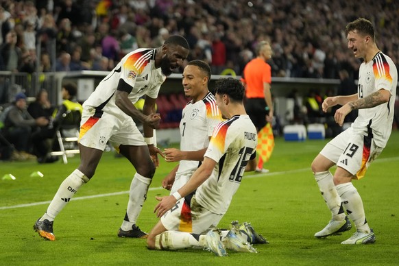 Germany&#039;s scorer Jamie Leweling, 2nd from left, celebrates with teammates after scoring the opening goal during the UEFA Nations League group 3 soccer match between Germany and The Netherlands in ...