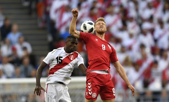 Peru&#039;s Christian Ramos, left, heads for the ball with Denmark&#039;s Nicolai Jorgensen during the group C match between Peru and Denmark at the 2018 soccer World Cup in the Mordovia Arena in Sara ...