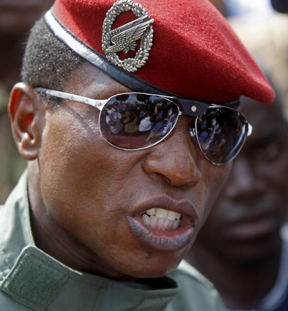 FILE- Former Guinea military coup leader Capt. Moussa Dadis Camara takes part in independence day celebrations in Conakry, Guinea, Oct. 2, 2009. Camara took the stand for the first time Monday Dec. 12 ...