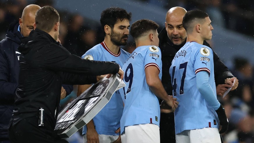 Manchester, England, 31st December 2022. Josep Guardiola manager of Manchester City makes a triple substitution during the Premier League match at the Etihad Stadium, Manchester. Picture credit should ...