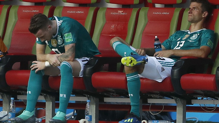 Germany&#039;s Marco Reus, left, and Germany&#039;s Thomas Mueller, right, sit dejected on the bench after the group F match between South Korea and Germany, at the 2018 soccer World Cup in the Kazan  ...