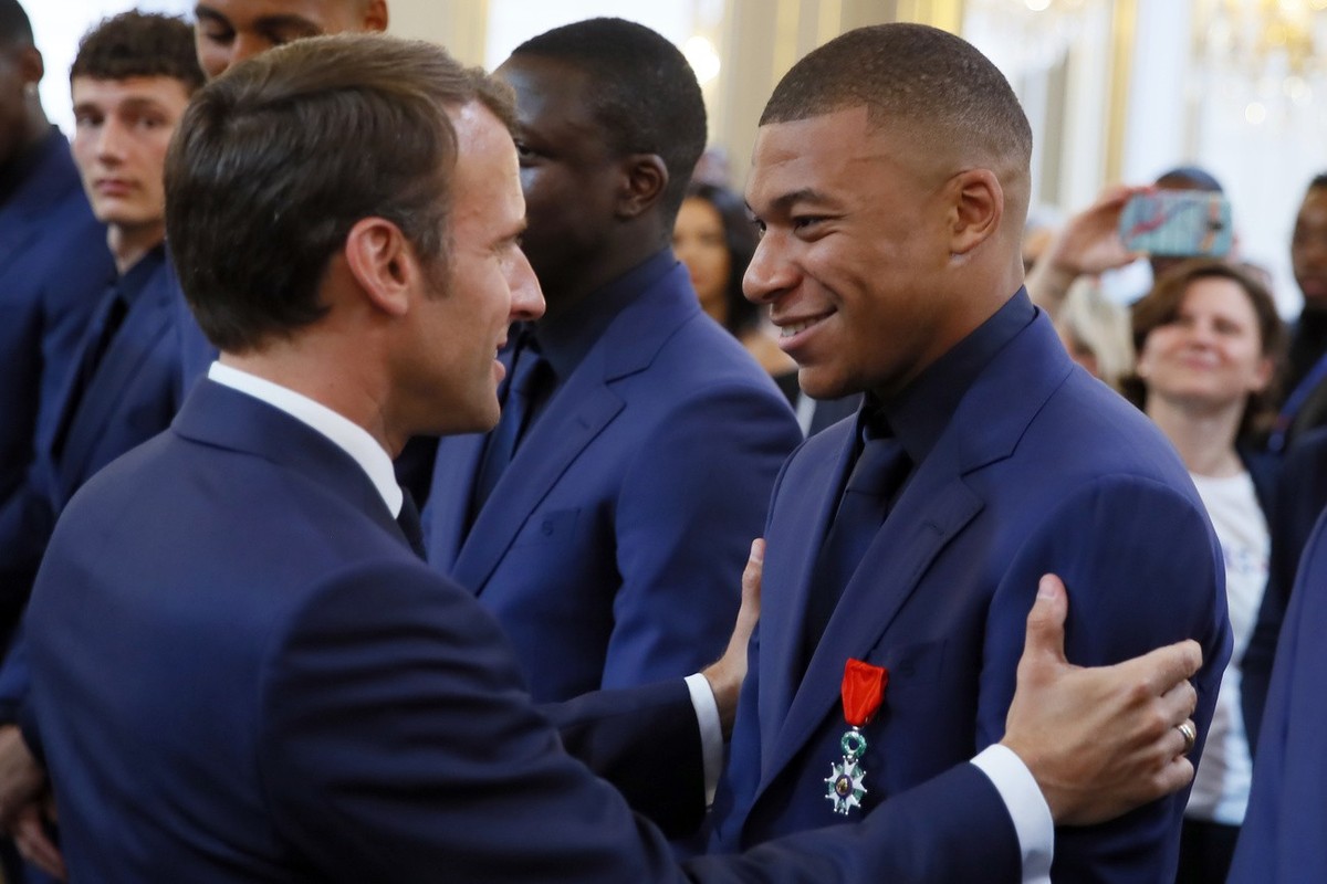 France soccer player Kylian Mbappe, right, is awarded of the Legion d'Honneur (Officer of the Legion of Honor) medal by French president Emmanuel Macron during a ceremony at the Elysee Palace in  ...