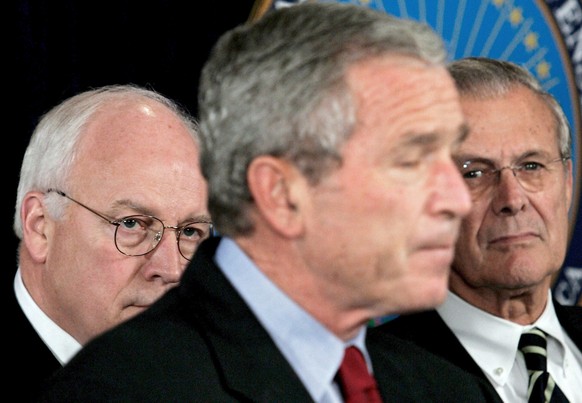 epa09314273 (FILE) - A file picture dated 22 September 2005 of then US President George W. Bush (C) pausing as he speaks on the war on terror as Vice President Dick Cheney (L) and Secretary of Defense ...
