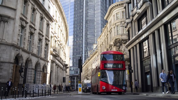 epa10213755 A double decker bus drives through the City of London in London, Britain, 29 September 2022. The Bank of England sets aside 65 billion pounds to buy bonds over the next days to ease the go ...