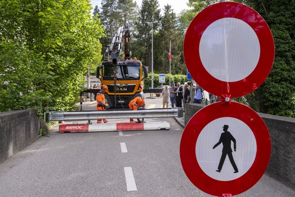 epa13030999 Workers place concrete barriers on a street to block access to the Hermance customs post, near Geneva, Switzerland, 11 June 2026, at the Franco-Swiss border during the G7 summit in nearby  ...