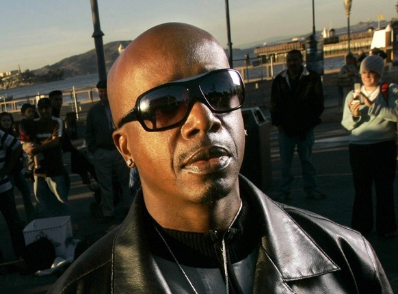 MC Hammer, Chief Strategy Officer for DanceJam.com, poses for a photograph as a dancer performs near Pier 41 in San Francisco, Tuesday, Nov. 20, 2007. The Web site, scheduled to debut in mid-January,  ...