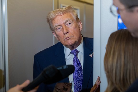 President Donald Trump speaks with reporters while in flight on Air Force One from his Mar-a-Lago estate in Palm Beach, Fla., to Joint Base Andrews, Sunday, Nov. 30, 2025. (AP Photo/Alex Brandon)
Dona ...