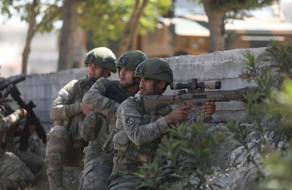 epa08417307 Turkish army soldiers guard the road and prevent civilians from ferrying to ensure protection for the Russian-Turkish joint patrol in Idlib, Syria, 12 May 2020. Turkey and Russia joint pat ...