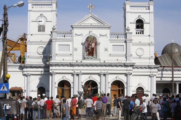 epa07520941 Sri Lankan people stand outside St. Anthony's Church in Kochchikade, Colombo, Sri Lanka, 22 April 2019. According to news reports, at least 290 people have been killed and over 500 in ...