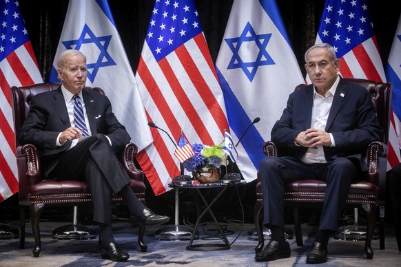 epa10925734 US President Joe Biden (L) looks on during a meeting with Israeli Prime Minister Benjamin Netanyahu (R) in Tel Aviv, Israel, 18 October 2023. President Biden pledged US support for Israel  ...