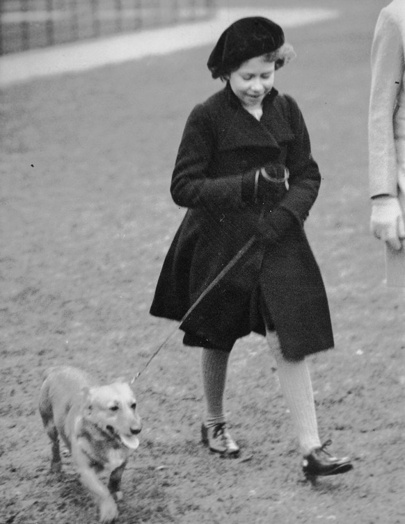 Princess Elizabeth takes her pet dog for a walk in Hyde Park, London, on Feb. 26. 1936. It���s widely known that Elizabeth loved corgi dogs, Princess Diana reportedly called the animals the queen���s  ...