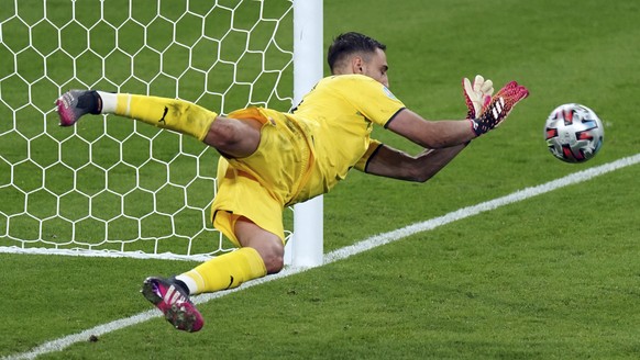 Italy goalkeeper Gianluigi Donnarumma makes a saves on a penalty shot from England&#039;s Bukayo Saka during the penalty shoot out during the Euro 2020 soccer championship final match between England  ...