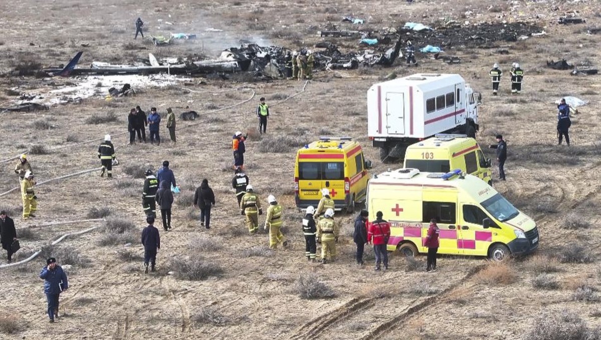 epa11792888 Emergency specialists work at the crash site of a passenger plane near Aktau, Kazakhstan, 25 December 2024. Azerbaijan Airlines Embraer ERJ-190AR passenger plane flying from Baku to Grozny ...