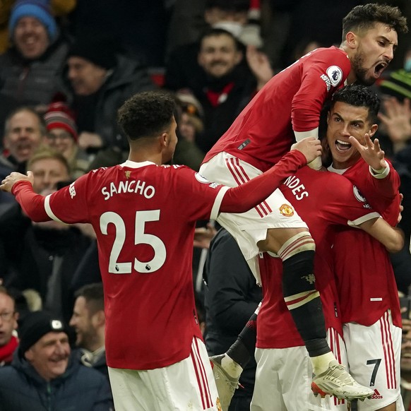 Manchester United&#039;s Cristiano Ronaldo, right, celebrates after scoring his side&#039;s second goal during the English Premier League soccer match between Manchester United and Arsenal at Old Traf ...