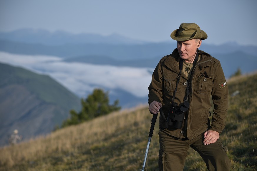 epa06976919 A photo made available on 27 August 2018 shows Russian President Vladimir Putin on an outdoor trip during his visit in the Tuva region in Siberia, Russia, 26 August 2018. EPA/ALEXEI NIKOLS ...