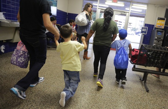 FILE - In this July 7, 2015, file photo, immigrants from El Salvador who entered the country illegally walk through a bus after they were released from a family detention center in San Antonio. With t ...