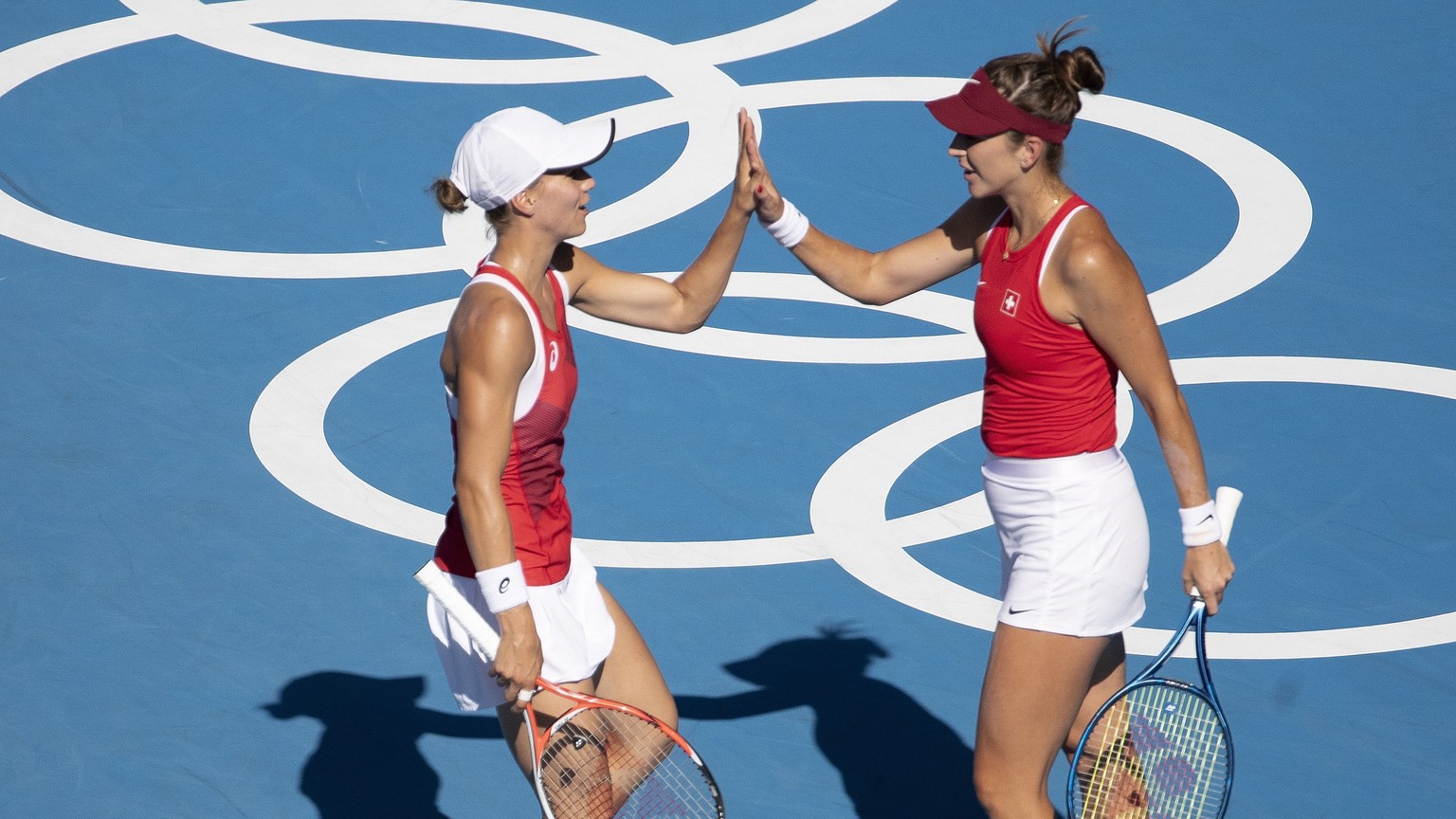 epa09384138 Belinda Bencic and Viktorija Golubic of Switzerland during the women&#039;s tennis doubles gold medal match against Barbora Krejcikova and Katerina Siniakova of The Czech Republic at the 2 ...